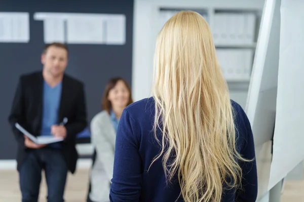 Blond businesswoman walking in the office — Stock Photo, Image