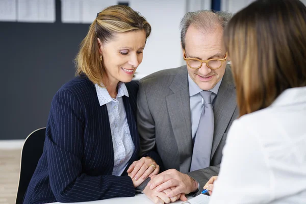 Middle-aged affectionate couple in a meeting — Stock Photo, Image