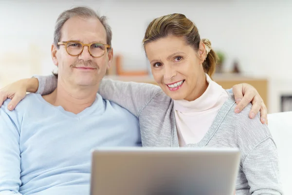 Avslappnad medelålders par använder bärbar dator — Stockfoto