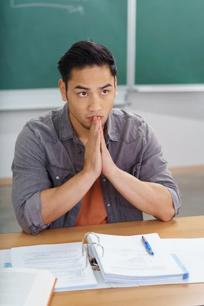 Asian male student thinking about his class work — Stock fotografie