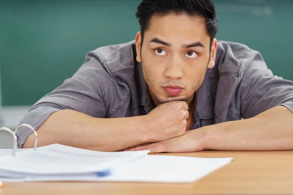 Thoughtful Asian student watching the lecture — Stockfoto