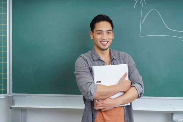 Confident young male student in a lecture room — Stock Photo, Image