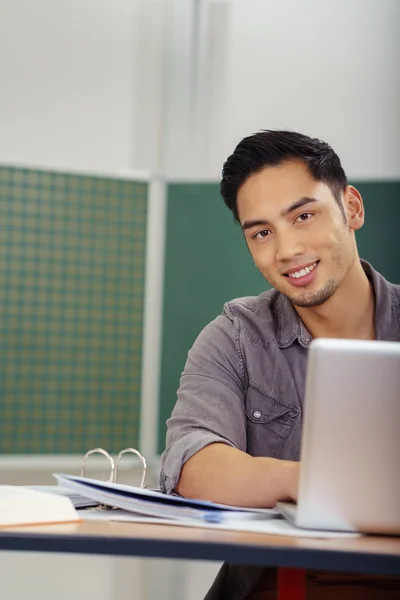 Smiling friendly young Asian student in class — Stock Photo, Image