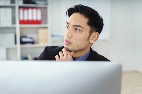 Thinking executive with fingers on chin — Stock Photo, Image