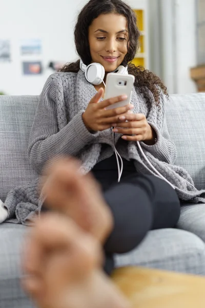 Mulher Relaxante em casa com leitor de música de telefone celular e fones de ouvido — Fotografia de Stock