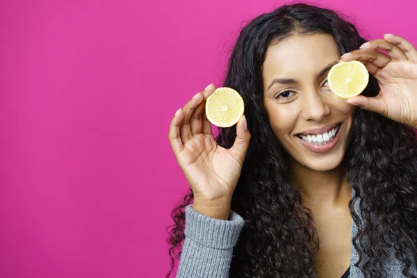 Playful Woman Holding Lime Slices in front of her face — Stok fotoğraf