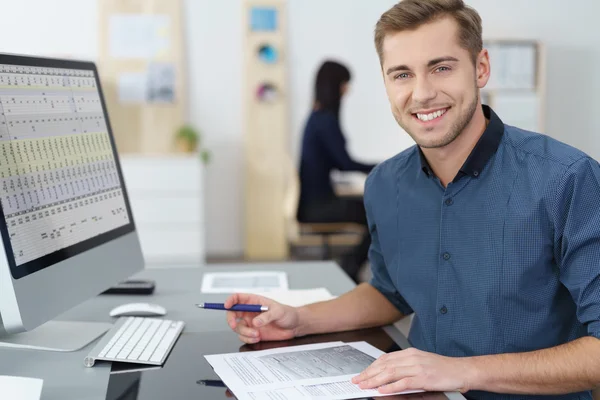 Happy successful young businessman at his desk — 스톡 사진