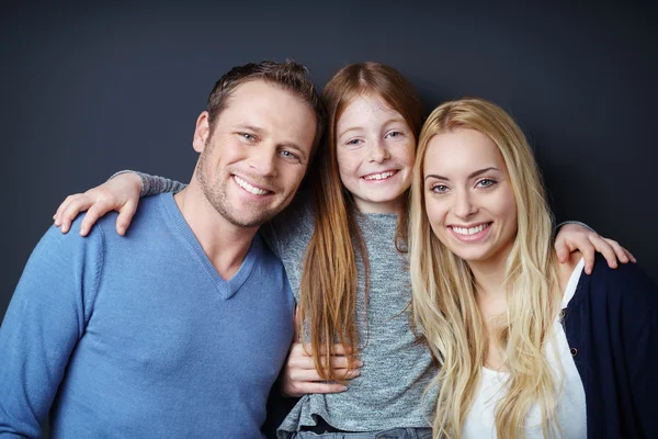 Attractive three member family embracing — Stock fotografie