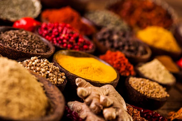 Colorful spices in wooden bowls