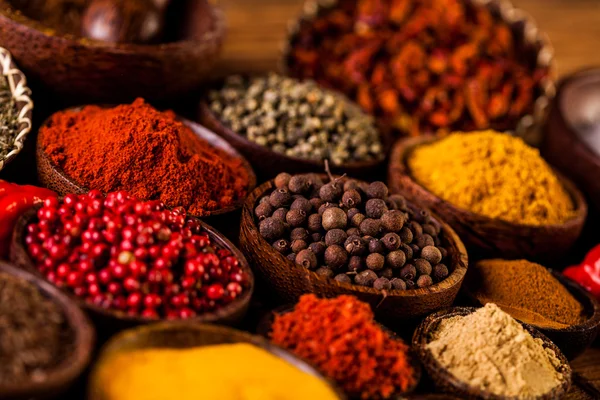 Colorful spices in wooden bowls — Stock Photo, Image