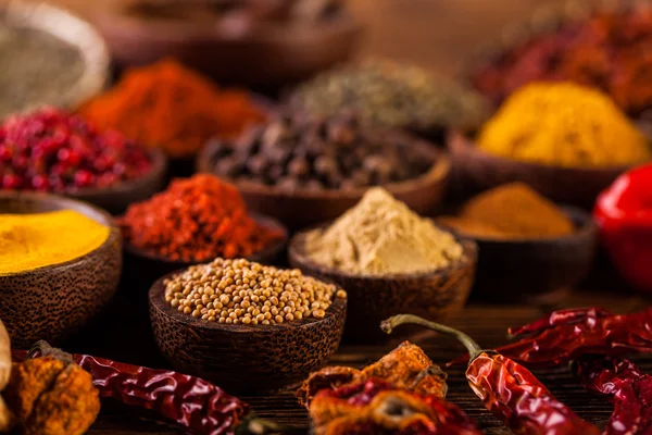 Wooden table of colorful spices — Stock Photo, Image