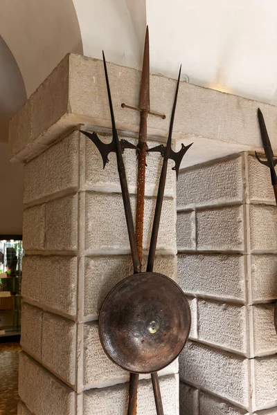 ancient weapons (spears,shields) in the courtyard of the Gothic Duino castle on a cliff above the Gulf of Trieste (Adriatic Sea), Italy