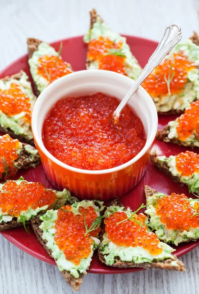 Caviar and avocado toasts — Stock Photo, Image