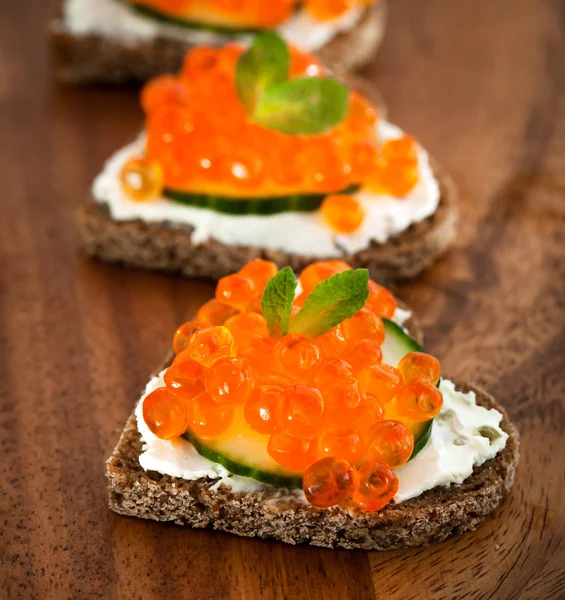 Heart shaped toasts with red caviar — Stock Photo, Image