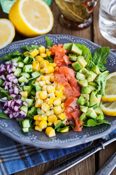 Salmon, avocado, corn, cucumber and onion salad — Stock Photo, Image