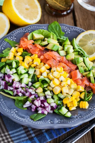 Salmon, avocado, corn, cucumber and onion salad — Stock Photo, Image