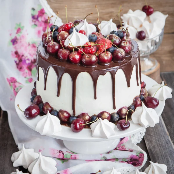 Cake versierd met verse bessen, chocolade en schuimgebak — Stockfoto