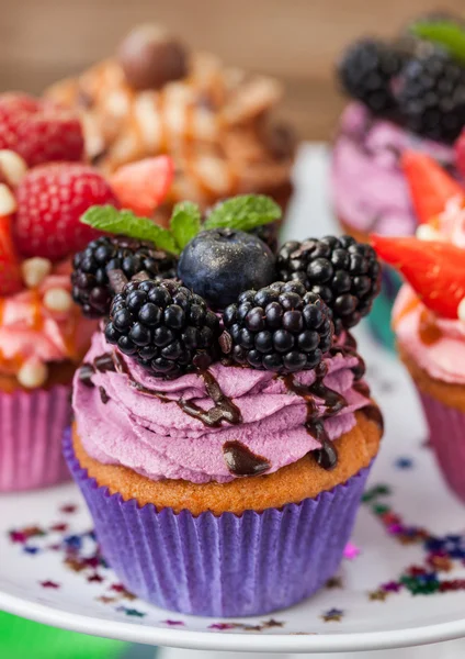 Delicious cupcake decorated with blueberry and blackberries — Stock Photo, Image