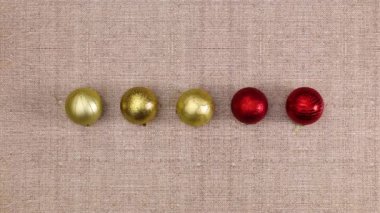 Beş kırmızı ve altın Noel süsü renk değiştiriyor. Döngü durdurma hareketi