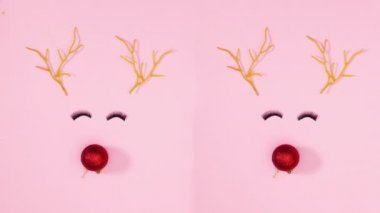 Pastel pembe arka planda göz kirpikleriyle yanıp sönen iki ren geyiği. Hareketi durdur