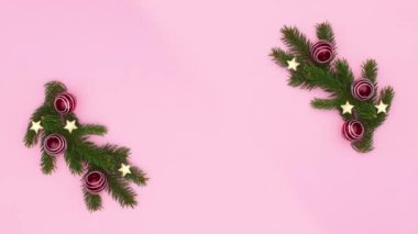 Pastel pembe temalı kırmızı süslemeli çam Noel çelengi. Hareketi durdur