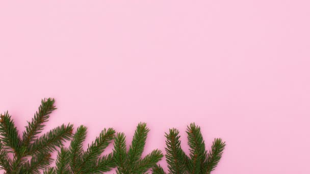 Christmas Decoration Pine Branches Ornaments Appear Bottom Pastel Pink Theme — Stock Video