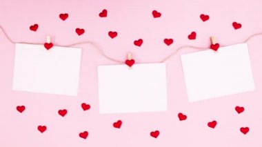 Sevgililer gününde kalpler ipte asılı kağıtların etrafında döner. Hareketi durdur