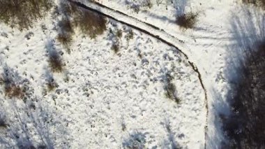 Kış mevsiminde karda patikaları olan bir yol. Hava görünümü 