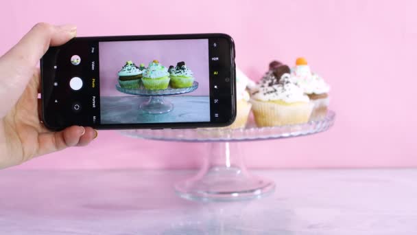Tirando Fotos Cupcakes Servidos Com Creme Branco Com Telefone Celular — Vídeo de Stock