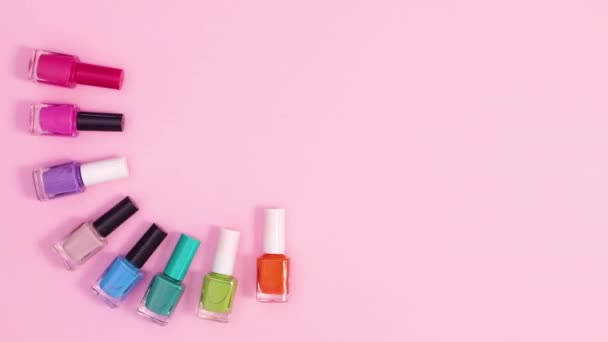 Manicure Nagellak Flessen Bewegen Aan Linkerkant Van Pastel Roze Achtergrond — Stockvideo