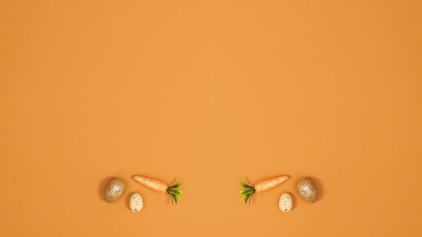 有创意的复活节作品 由鸡蛋和胡萝卜制成 背景橙色 并有复制空间 停止运动 — 图库视频影像