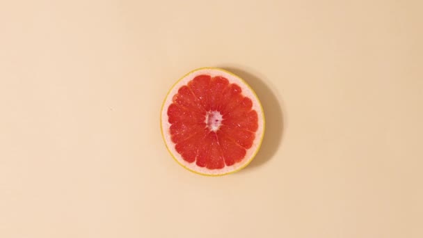 Zitrusgrapefruit Rotierend Auf Beigem Hintergrund Stop Motion — Stockvideo