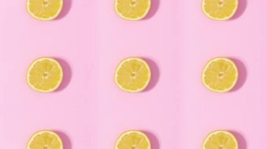 Pastel pembe arka planda dönen ve değişen turunçgillerden oluşan yaratıcı desen. Hareketi durdur