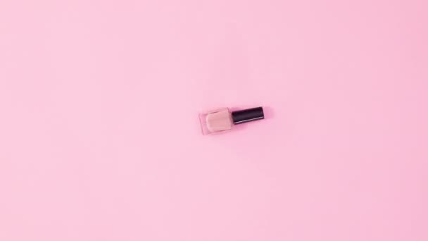 Manicure Nail Polish Bottle Rotating Pastel Pink Background Stop Motion — Stock Video