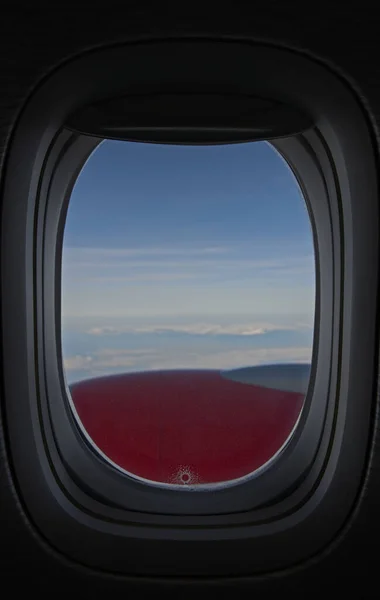 blue cloudy sky in the afternoon from the window of a high flying plane