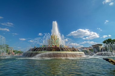 water jets of the fountain on a clear summer day. stone flower fountain