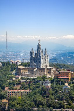 Tibidabo church on mountain in Barcelona with christ statue over clipart