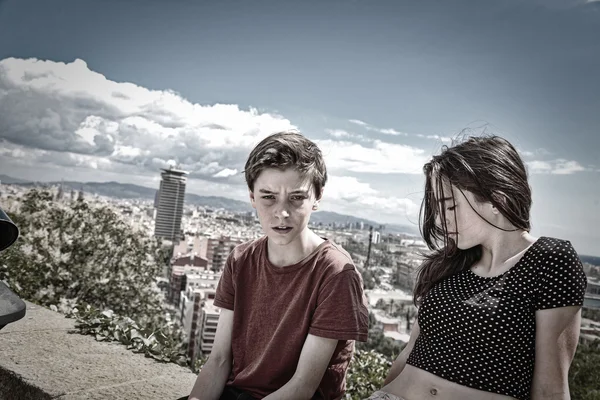 Siblings sitting on a wall with Barcelona in background — Stock Photo, Image