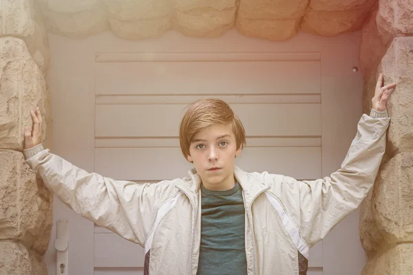 Cool teenager boy standing in an entrance — Stock Photo, Image