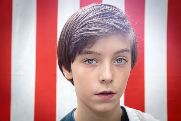 Kırmızı ve beyaz önünde bir yakışıklı genç çocuk portresi — Stok fotoğraf