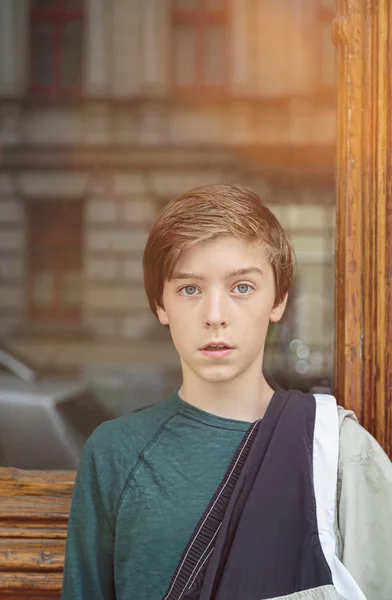 Portrait of a teenager boy in front of a glass panel — Stock Photo, Image