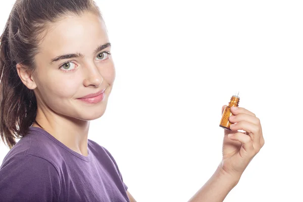 Smiling woman is holding a bottle of homeopathic medicine, isola — Stock Photo, Image