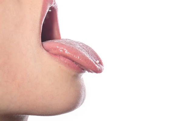 Woman with a homeopathic globules on the tip of her tongue, isol — Stock Photo, Image