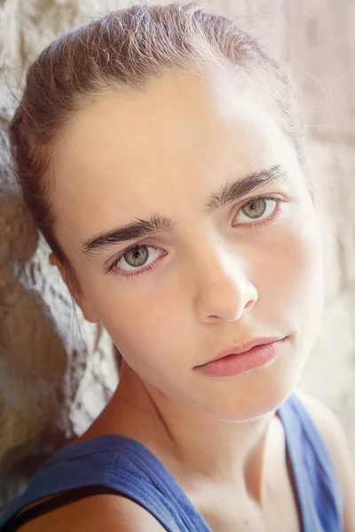 Portrait of a sulking teenage girl, leaning against a wall — Stock Photo, Image