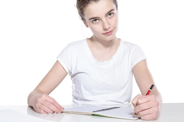 Smiling teenage girl with copy book and pencil, isolated on whit — Stock Photo, Image