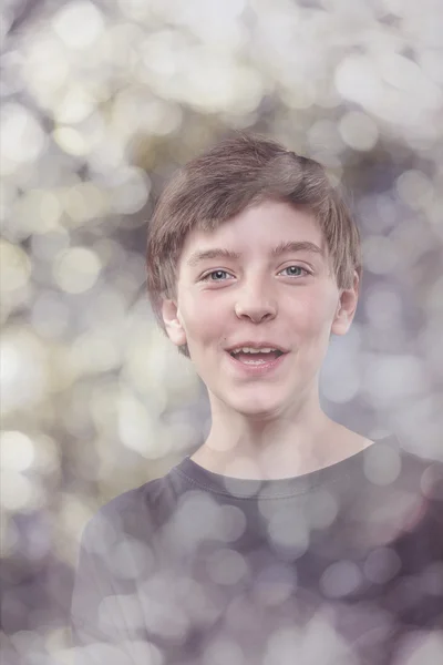 Portrait of a lucky teenage boy, with bokeh around — Stock Photo, Image