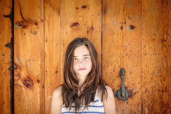 Portrait of a beautiful teenage girl in front of an ancient wood — Stock Photo, Image