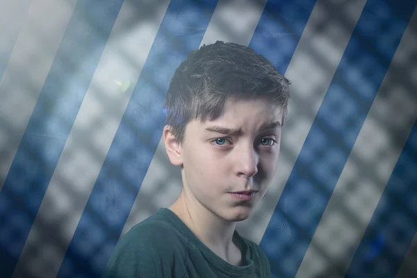 Portrait of a doubting teenage boy with flare, striped backgroun — Stock Photo, Image