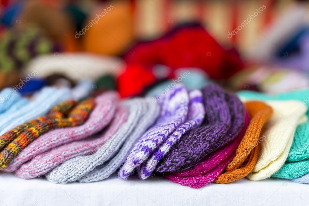 a  row of multicolored hand-knitted baby socks