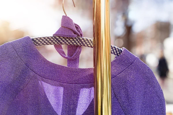 Pullover hanging on a wardrobe rail on a flea market — Stock Photo, Image